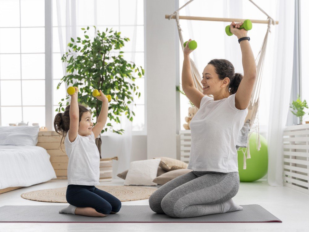 full shot adult kid holding dumbbells